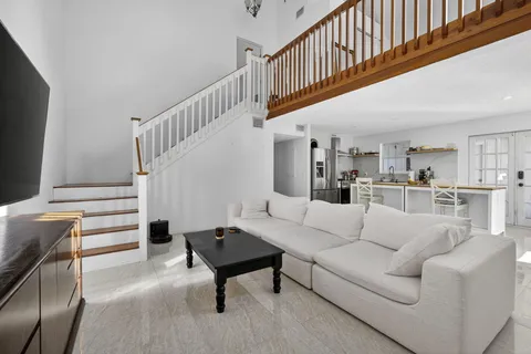 a view of a room with wooden floor and windows