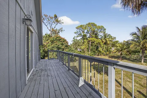 a view of a hallway with windows and stairs