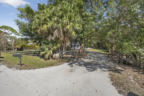 a view of an empty room with balcony and floor to ceiling window