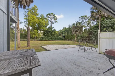 an aerial view of residential houses with outdoor space and trees