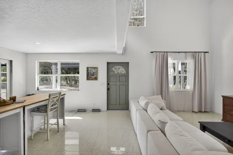 a utility room with stainless steel appliances granite countertop a stove and a sink