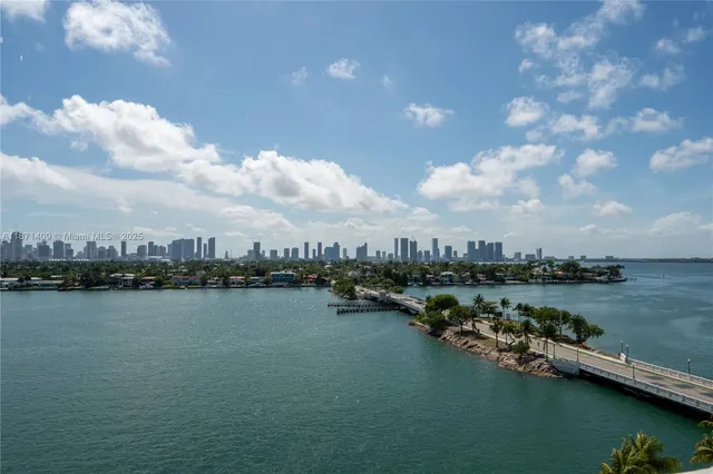 a view of a lake with houses in back