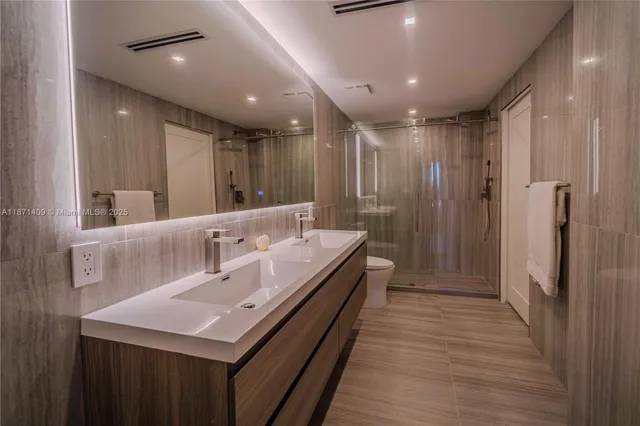 a bathroom with a double vanity sink and a mirror