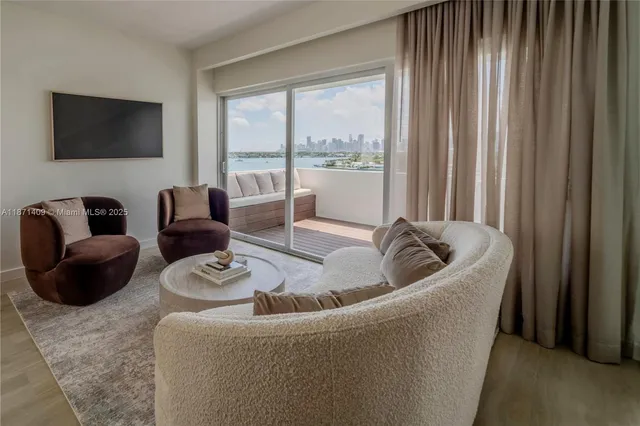 a living room with furniture and a floor to ceiling window
