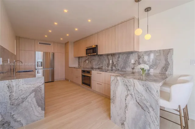a kitchen with stainless steel appliances granite countertop a sink and cabinets
