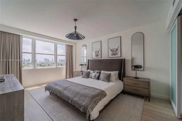 a bedroom with a large bed and a window