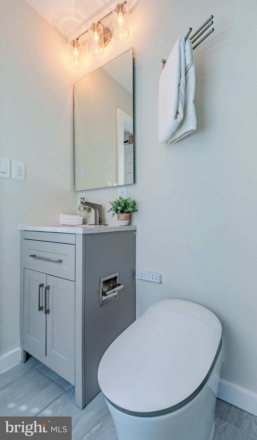 9544 Gunhill Circle Nottingham, MD 21236 - Photo 23 of 56 a bathroom with a sink a mirror and a toilet