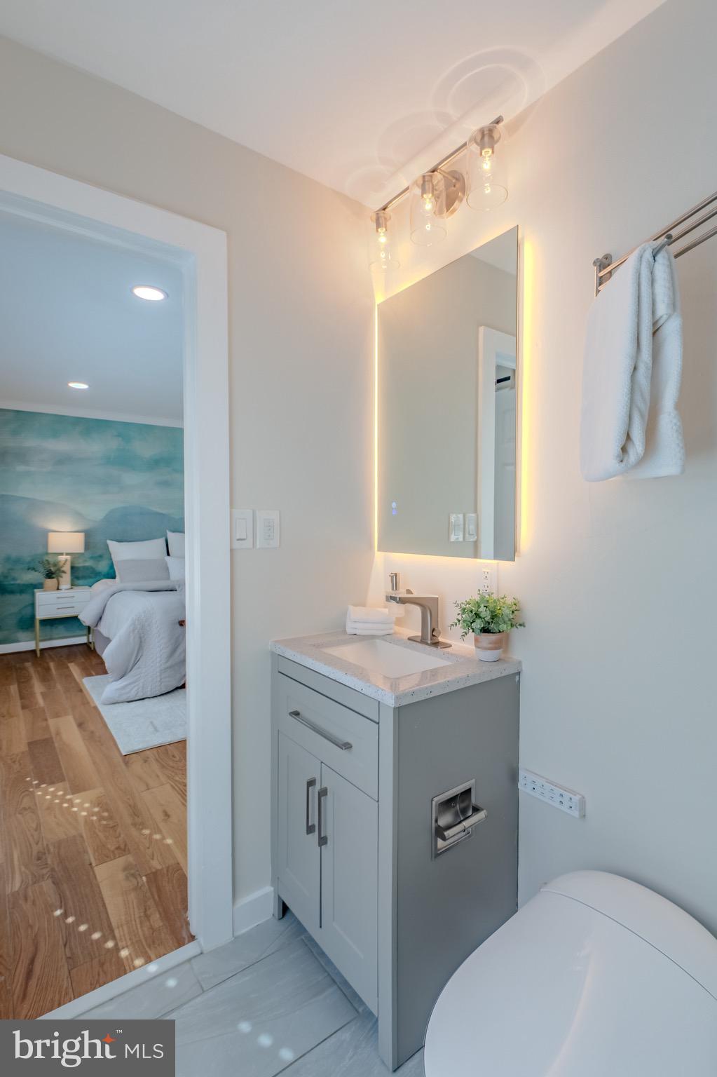 9544 Gunhill Circle Nottingham, MD 21236 - Photo 24 of 56 a bathroom with a granite countertop sink a toilet and mirror