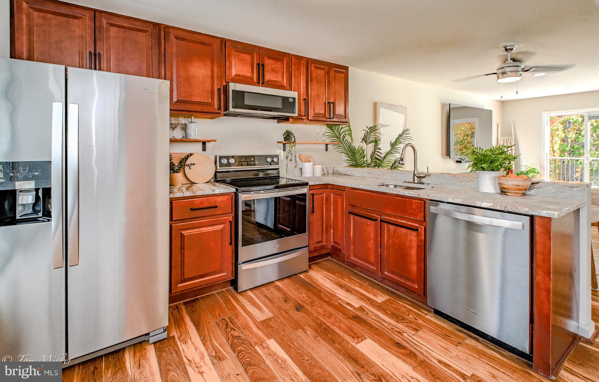 9544 Gunhill Circle Nottingham, MD 21236 - Photo 7 of 56 a kitchen with stainless steel appliances a stove a sink and a refrigerator