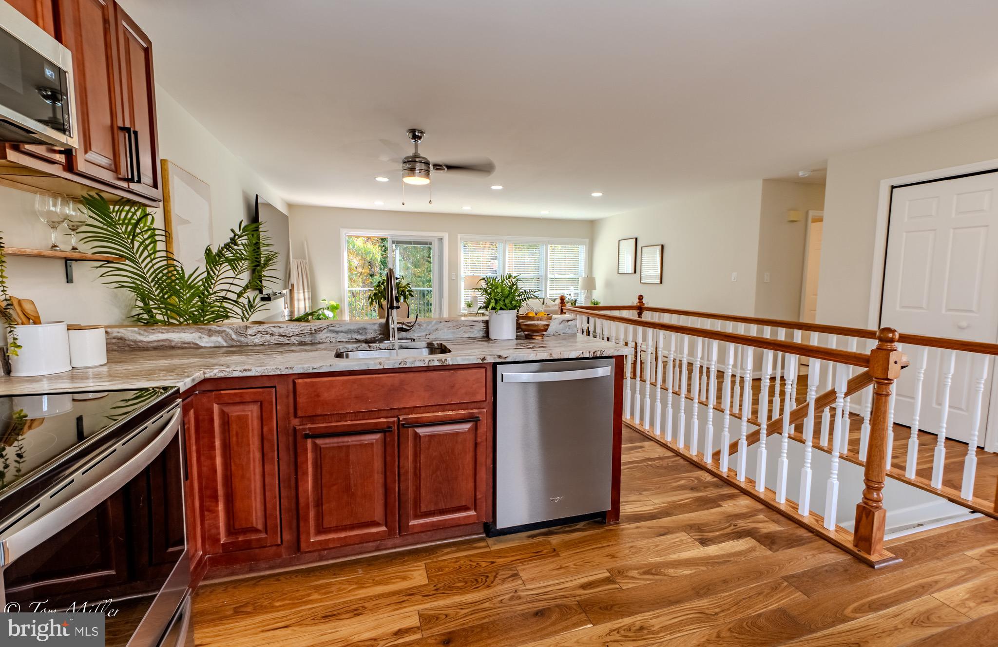 9544 Gunhill Circle Nottingham, MD 21236 - Photo 9 of 56 a kitchen with stainless steel appliances granite countertop a stove a sink dishwasher and a refrigerator with wooden floor