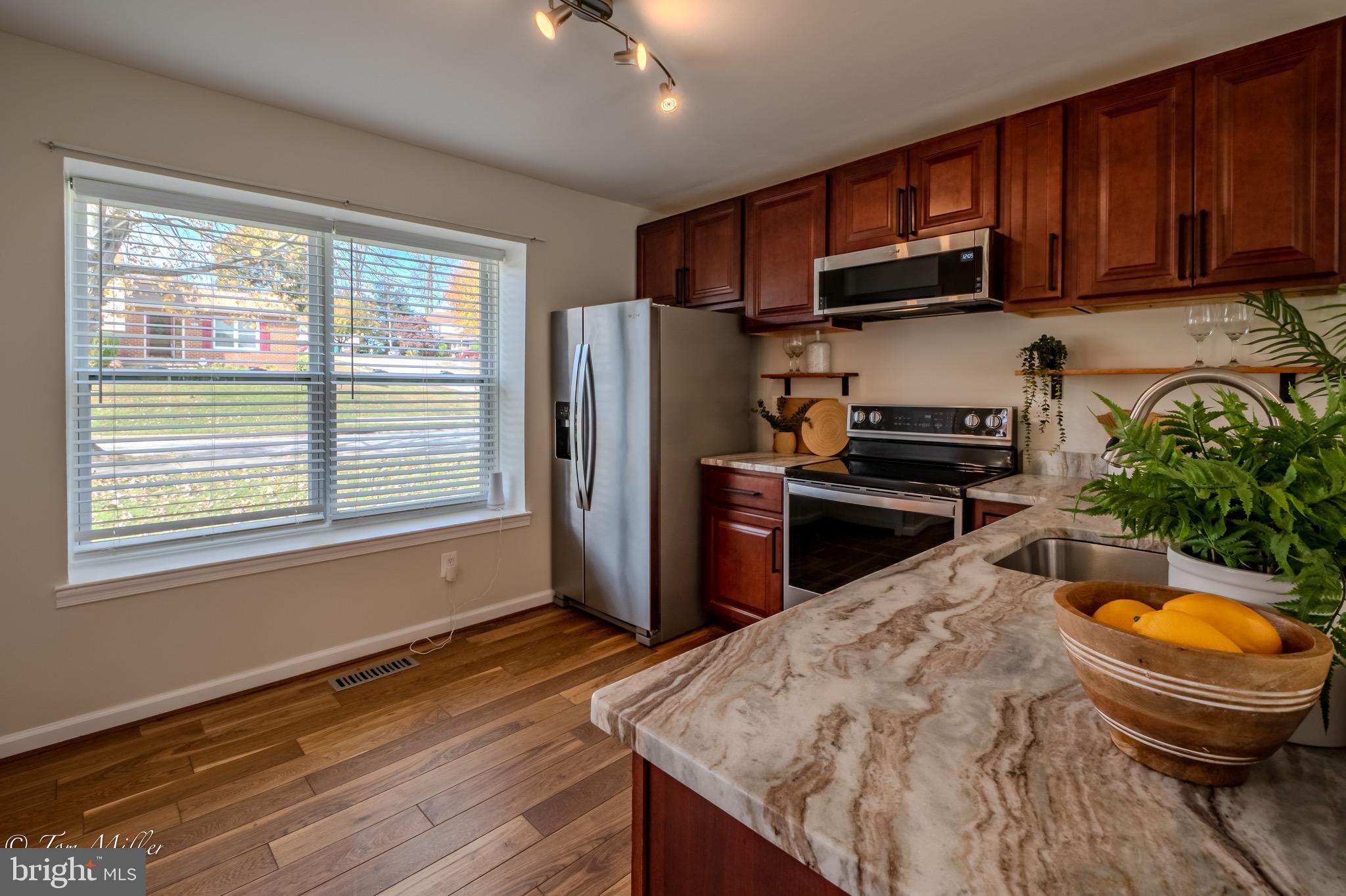 9544 Gunhill Circle Nottingham, MD 21236 - Photo 10 of 56 a kitchen with stainless steel appliances granite countertop a sink a stove a refrigerator cabinets and wooden floor