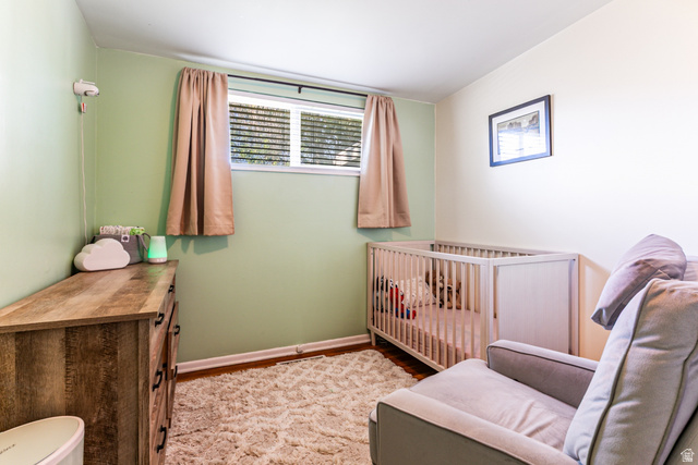 1619 Davis Drive Layton, UT 84041 - Photo 16 of 27 Bedroom with light green and white painted walls, hardwood flooring, and a window with horizontal blinds.
