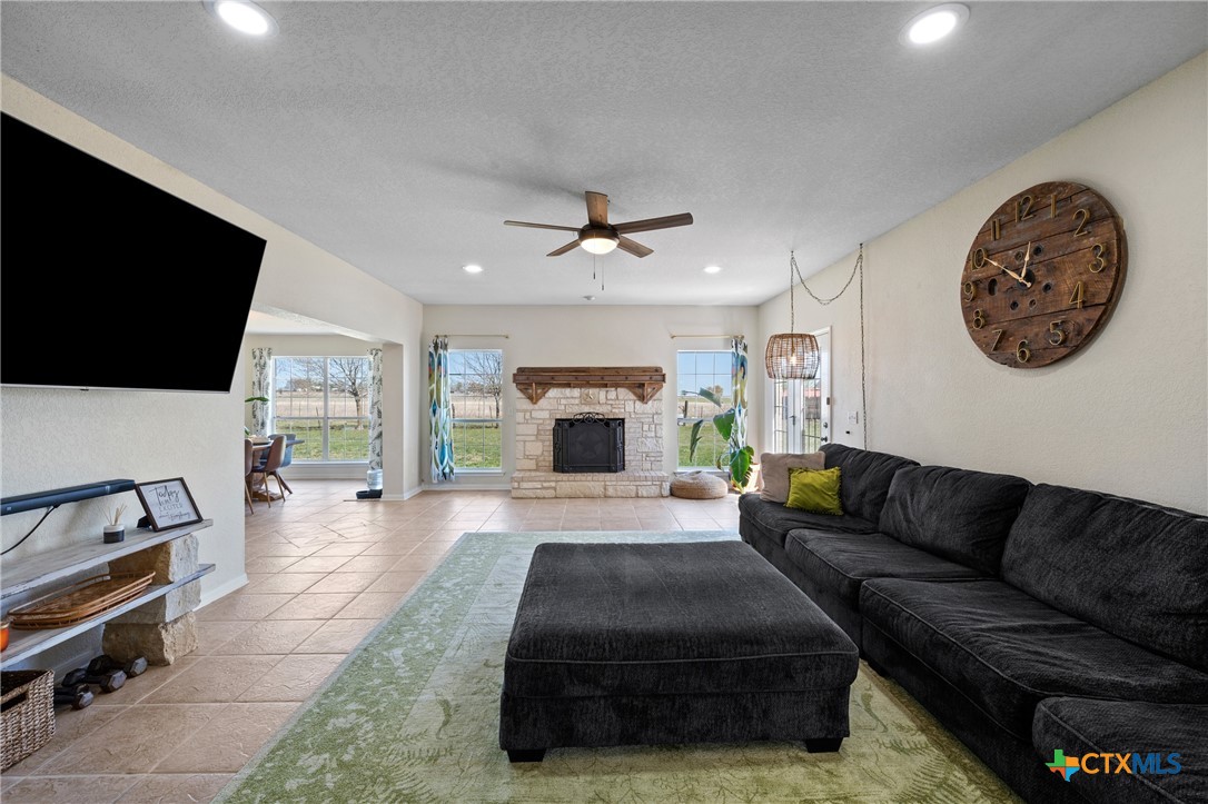 3000 West Amity Road Belton, TX 76513 - Photo 11 of 45 a living room with furniture a flat screen tv and a fireplace