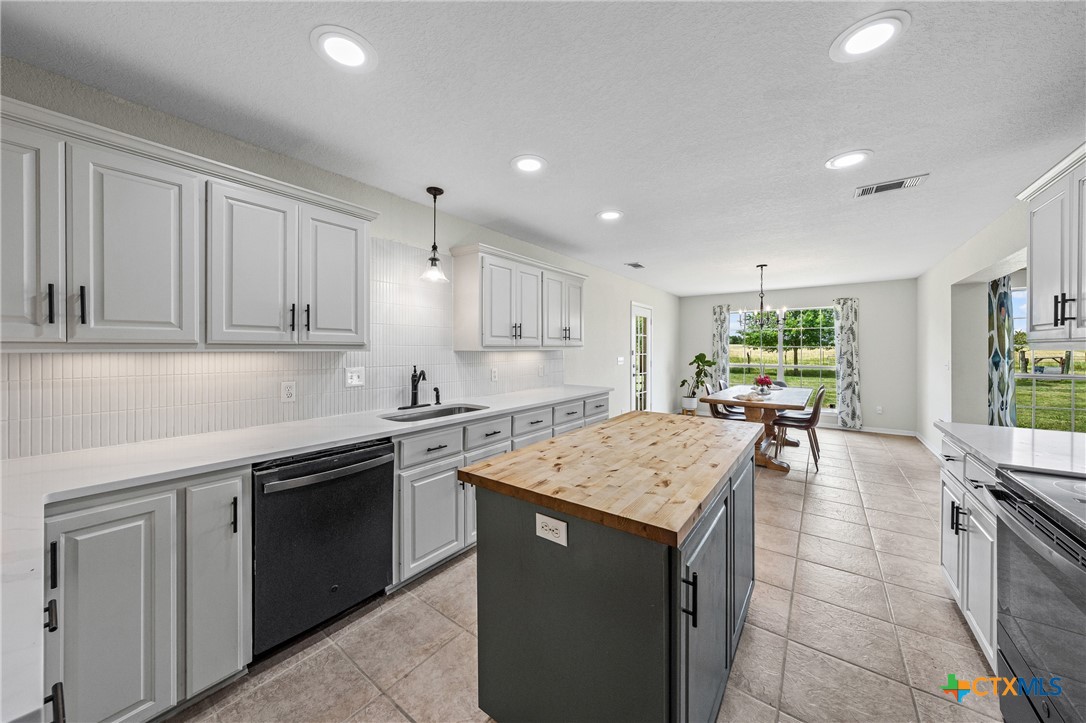 3000 West Amity Road Belton, TX 76513 - Photo 16 of 45 a kitchen with a stove sink and cabinets