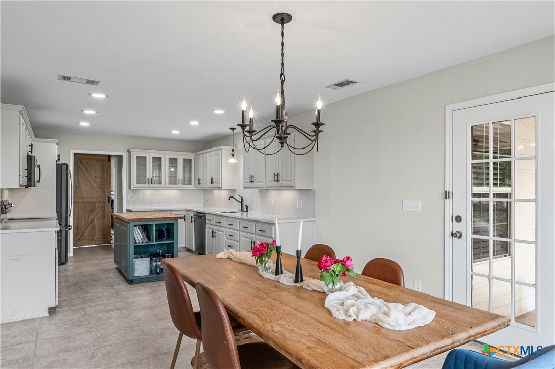 3000 West Amity Road Belton, TX 76513 - Photo 17 of 45 a view of a dining room and a kitchen with a table chairs