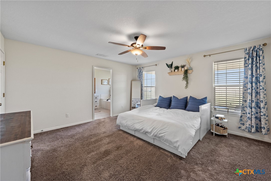 3000 West Amity Road Belton, TX 76513 - Photo 19 of 45 a bedroom with a bed and a chandelier