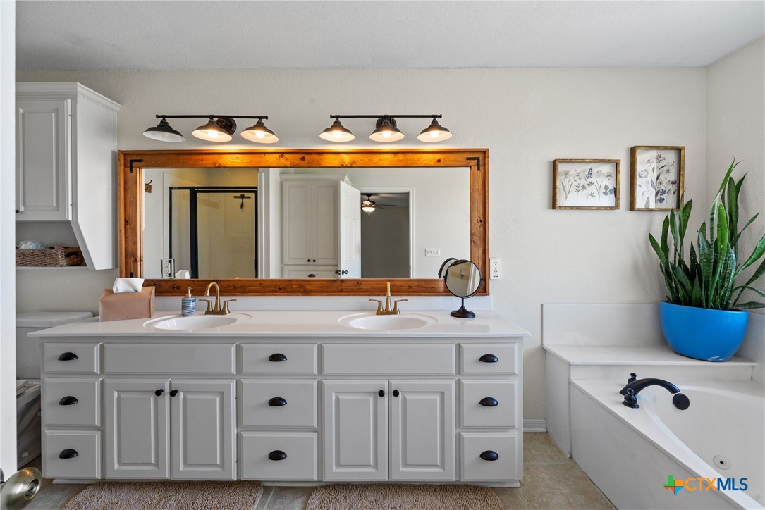 3000 West Amity Road Belton, TX 76513 - Photo 20 of 45 a bathroom with double vanity and a mirror