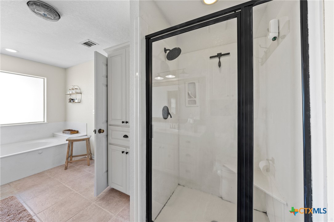 3000 West Amity Road Belton, TX 76513 - Photo 22 of 45 a bathroom with a bathtub and a shower
