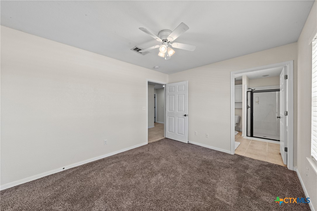 3000 West Amity Road Belton, TX 76513 - Photo 28 of 45 a view of an empty room with window and chandelier fan