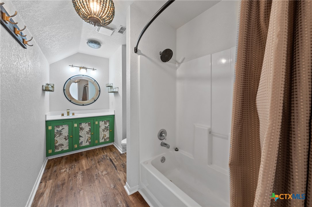 3000 West Amity Road Belton, TX 76513 - Photo 34 of 45 a bathroom with a sink a mirror and shower