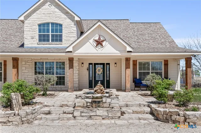 front view of a house with a lounge chair