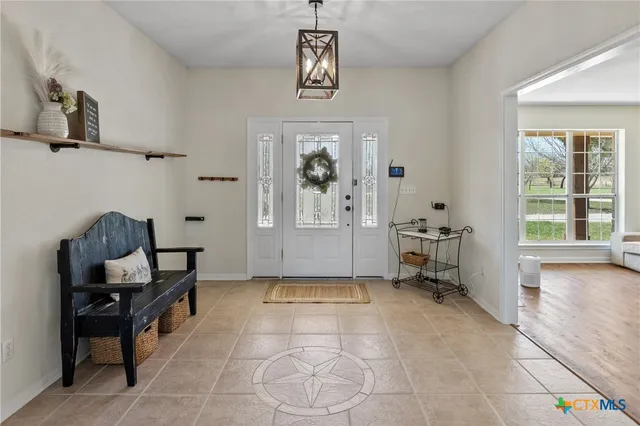 a view of a livingroom with workspace and a window