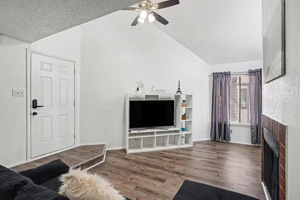 a kitchen with granite countertop a refrigerator and a stove top oven
