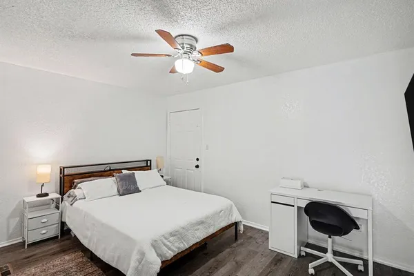 a bathroom with a granite countertop sink and a bathtub