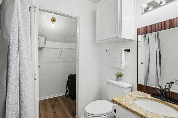 a bathroom with a sink a toilet and a mirror