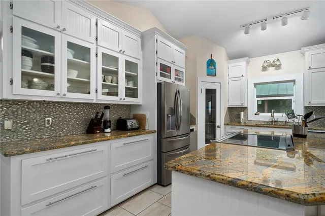 a bathroom with a glass shower door and a bathroom