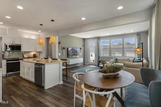 a kitchen with a dining table and chairs