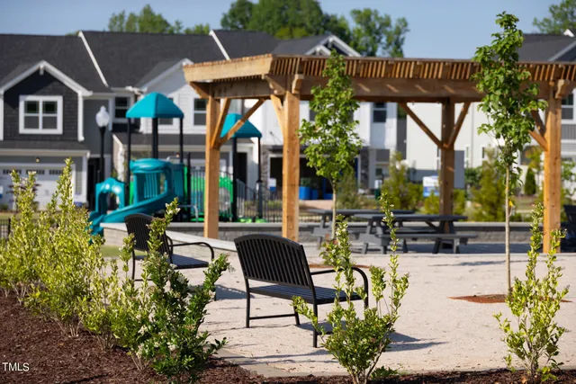 a view of a patio with couches table and chairs and potted plants