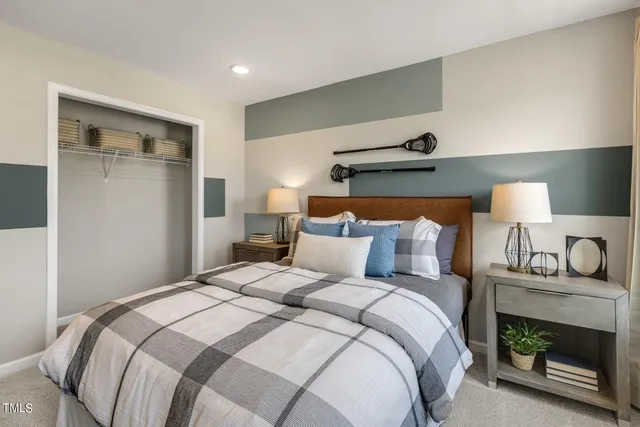 a bedroom with a bed and a lamp