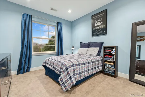 a bed sitting in a bedroom next to a window