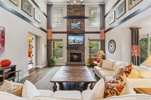 a living room with furniture a fireplace and wall paintings