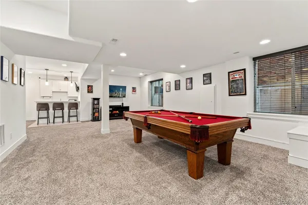 a room with furniture pool table and windows