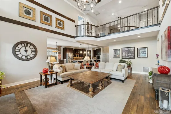 a living room with furniture gym equipment and a chandelier