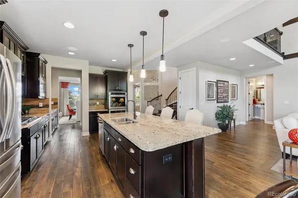 a kitchen with center island and wooden floor