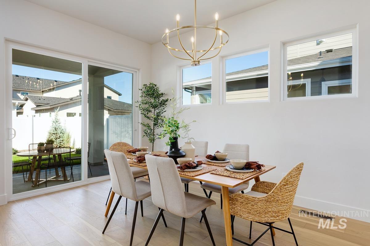 5817 South Gustav Avenue Meridian, ID 83642 - Photo 10 of 33 Dining area featuring light wood-finish flooring and a contemporary chandelier