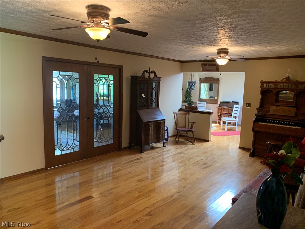 303 Orchard View Road Northeast Lancaster, OH 43130 - Photo 19 of 50 Miscellaneous room with a wealth of natural light, french doors, ceiling fan, and light hardwood / wood-style floors