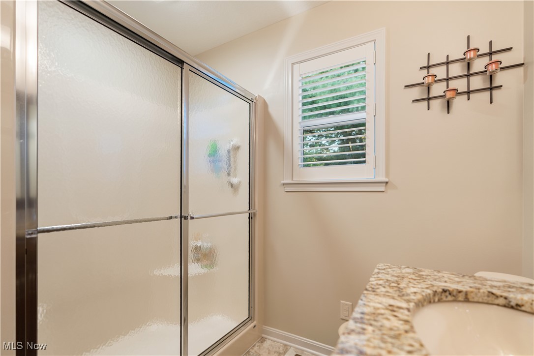 6408 Rustic Ridge Circle Northwest Massillon, OH 44646 - Photo 25 of 31 Bathroom featuring vanity and a shower with shower door