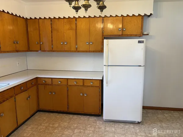 a kitchen with cabinets and white appliances