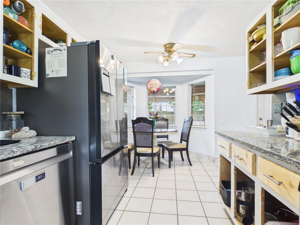 800 Rio Grande Lane Bryan, TX 77801 - Photo 7 of 23 a dining hall with stainless steel appliances granite countertop a dining table chairs and a refrigerator
