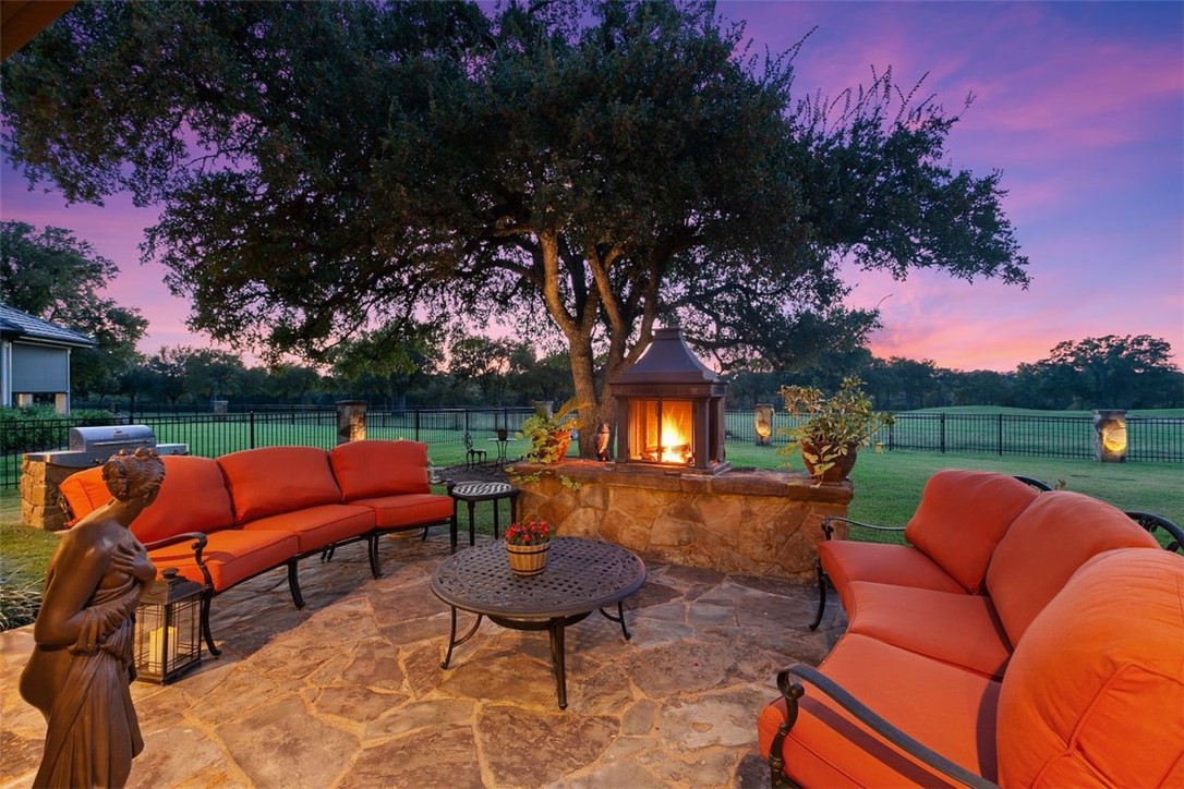a backyard of a house with fire pit and outdoor seating