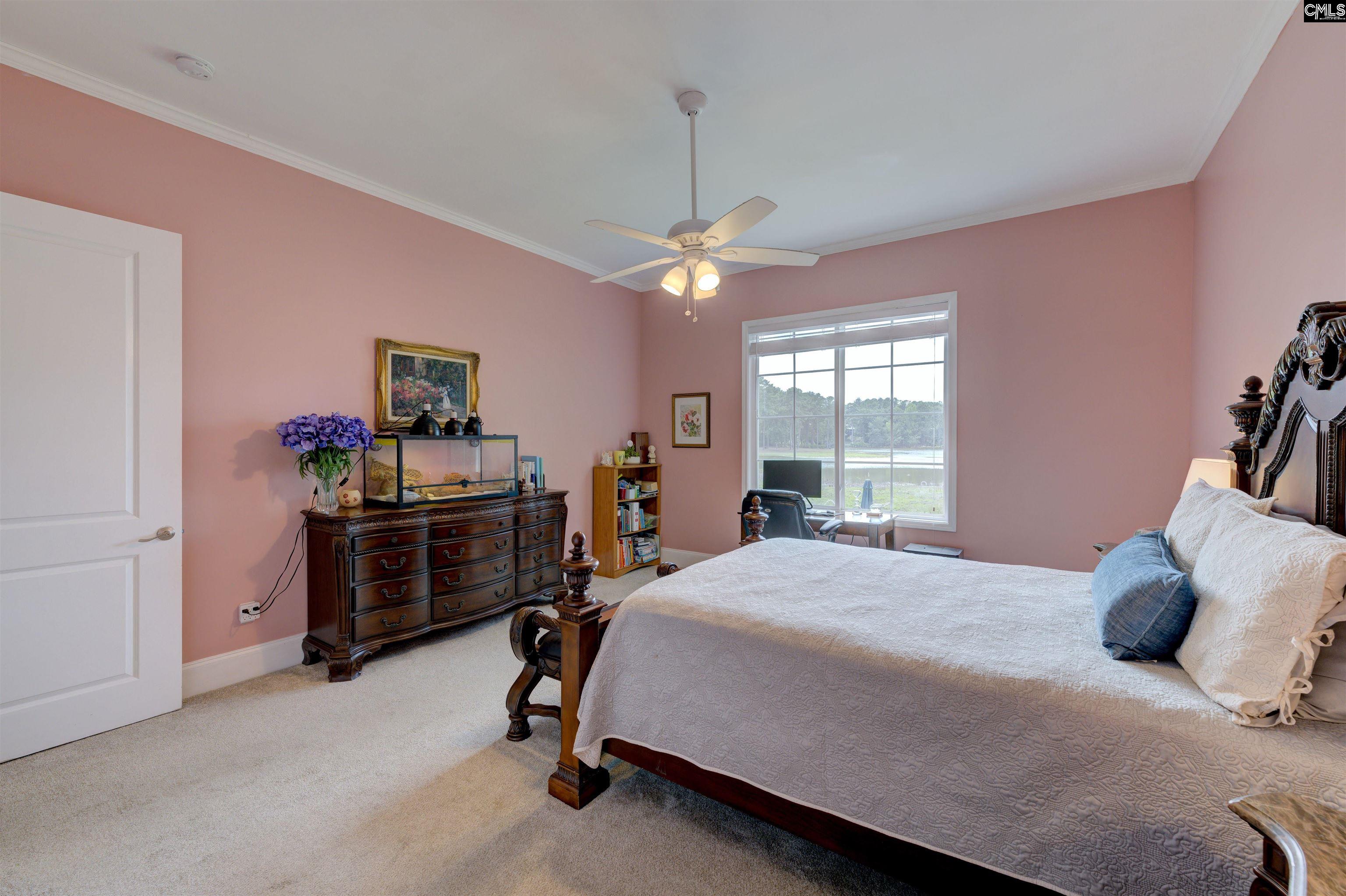 305 Northlake Road Columbia, SC 29223 - Photo 26 of 46 a bedroom with a bed and a chandelier