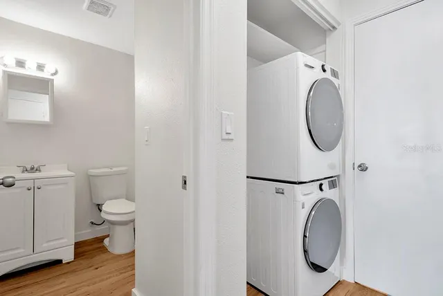 a bathroom with a toilet mirror and vanity