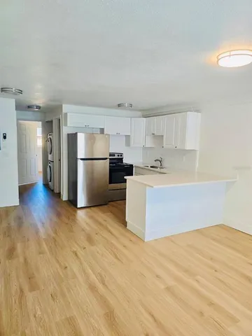 a kitchen with stainless steel appliances a refrigerator and a sink