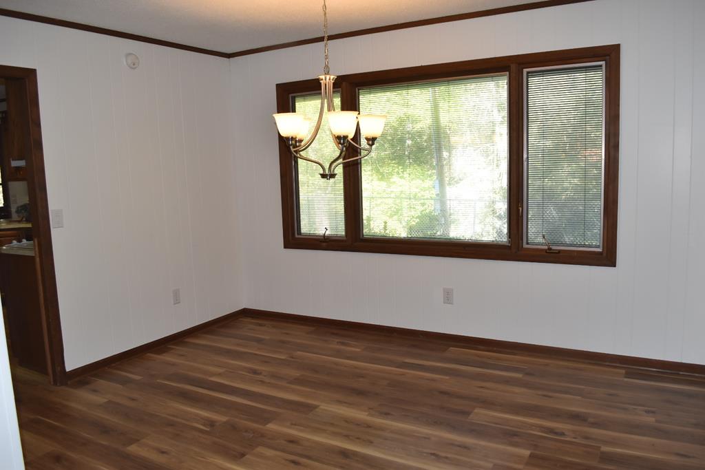 959 Pleasant Valley Road Murphy, NC 28906 - Photo 11 of 18 a view of an empty room with wooden floor and a window