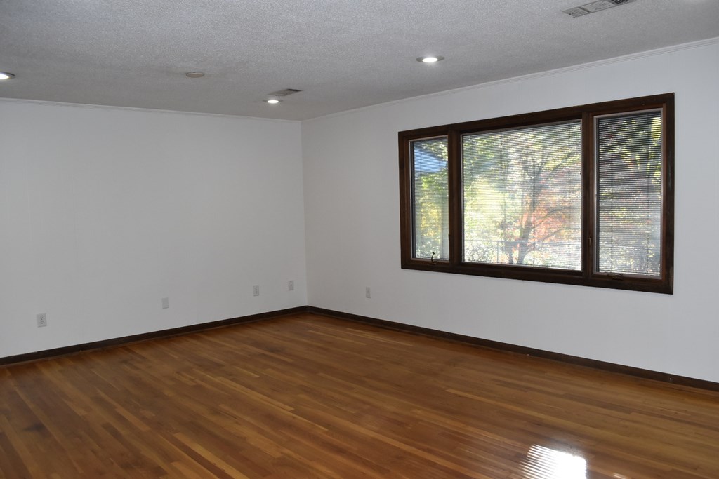 959 Pleasant Valley Road Murphy, NC 28906 - Photo 4 of 18 a view of an empty room with wooden floor and a window