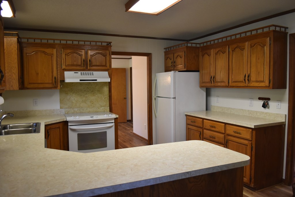 959 Pleasant Valley Road Murphy, NC 28906 - Photo 8 of 18 a kitchen with stainless steel appliances a refrigerator and a stove top oven
